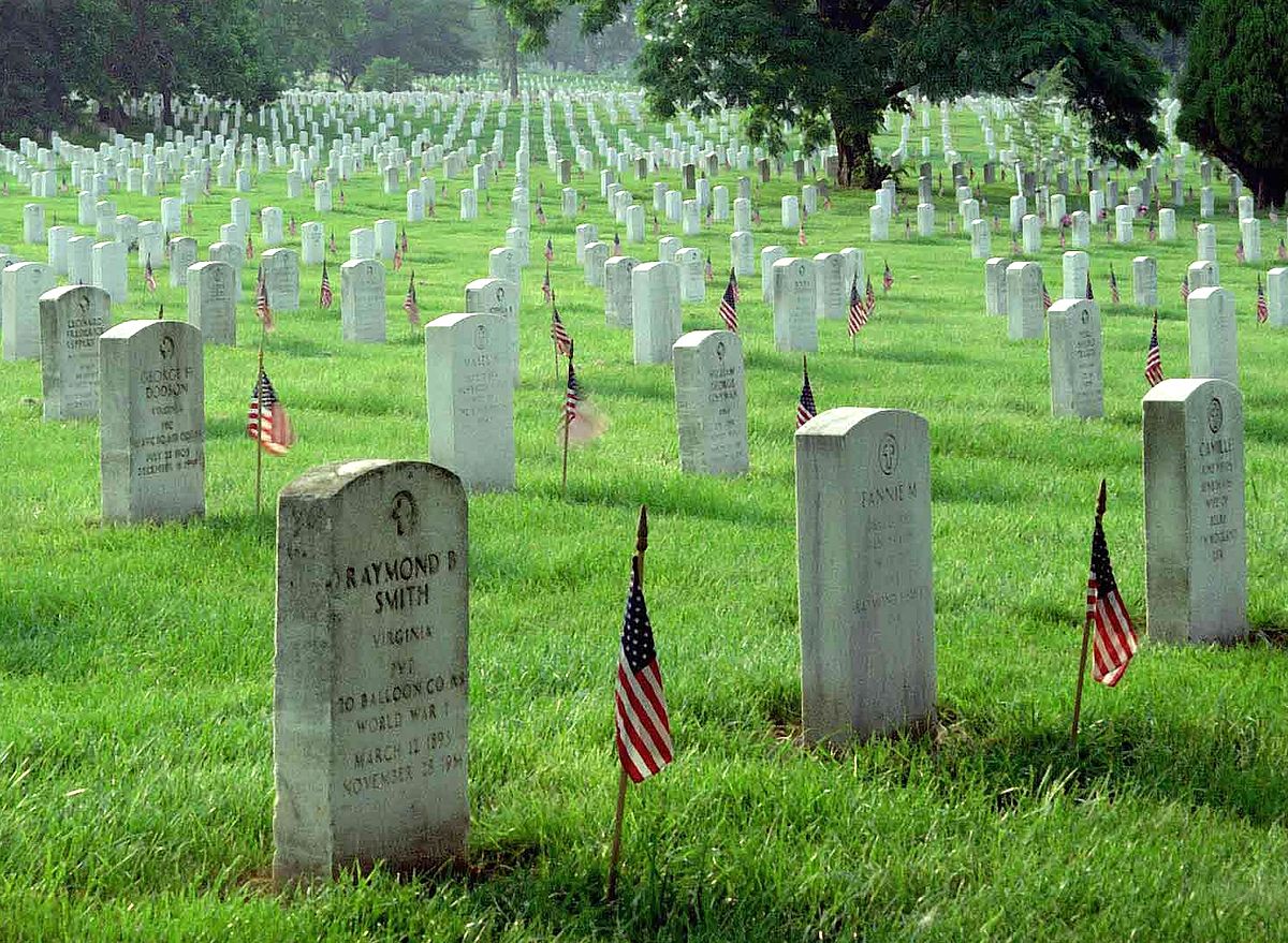 The graves at Arlington National Cemetary with small American flags in front of them.